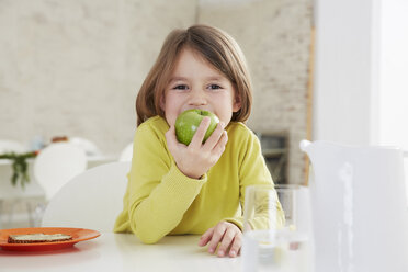 https://us.images.westend61.de/0000319816j/germany-munich-girl-sitting-at-table-with-green-apple-FSF000176.jpg