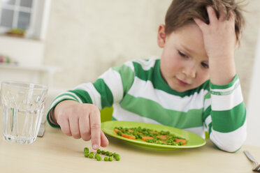 Germany, Munich , Boy doesn't want to eat peas and carrots - FSF000143