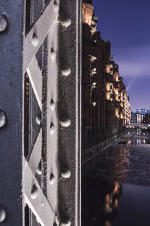 Germany, Hamburg, Illuminated Pillar of a girder bridge in the historic warehouse district - NKF000053