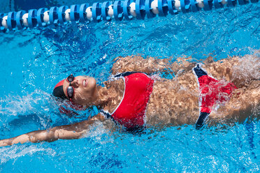 Woman with red bikini swimming in pool - EGF000086