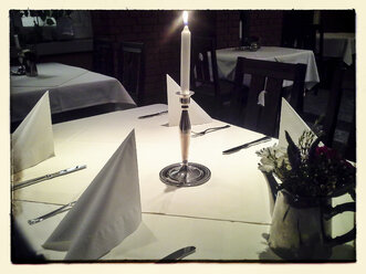 Gedeckter Restauranttisch mit einer brennenden Kerze - HAF000258
