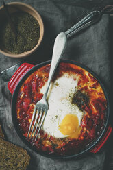 Shakshouka (Israeli peppers and tomato casserole with egg), bowl with za'atar (Middle Eastern spice mix), bread and cutlery, Studio - SBDF000551