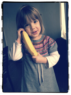 Little girl with banana as a telephone - LVF000623