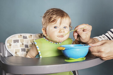 Baby in highchair being fed - IPF000009