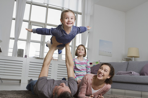 Playful family in living room stock photo