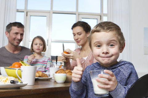 Family of four having healthy breakfast stock photo