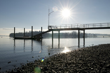 Germany, Baden-Wuerttemberg, Constance District, Lake Constance, Mainau, jetty against the sun - JEDF000163