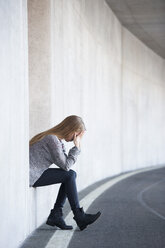 Portrait of unhappy teenage girl with hands on face - WWF003216