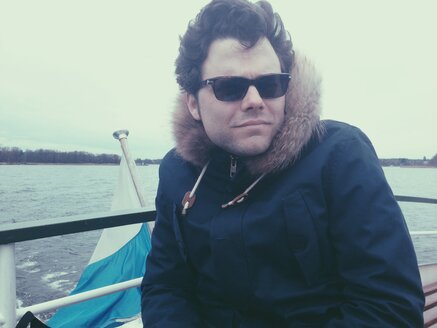 Man with sunglasses looking out on water boat, Chiemsee, Bavaria, Germany - MEAF000197