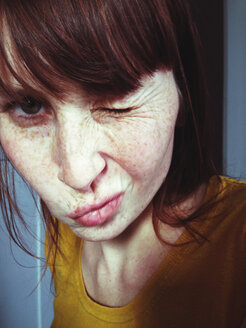 Close-up of woman with freckles waving towards camera - MEAF000210