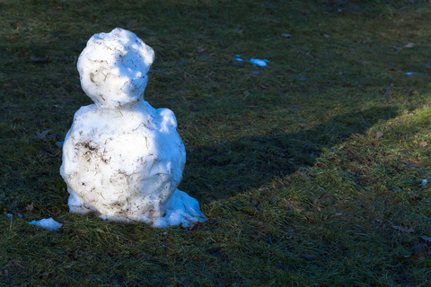 Deutschland, Reste von Schneemann auf einer Wiese, lizenzfreies Stockfoto