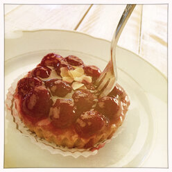 Cherry tart on white plate, Freiburg, Germany - DRF000525