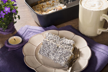 Plate with two slices of poppy seed cake on laid table - CSTF000068