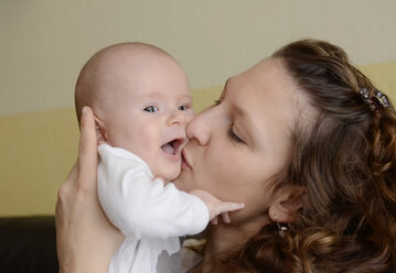 Mother kissing her happy baby boy - BFRF000351