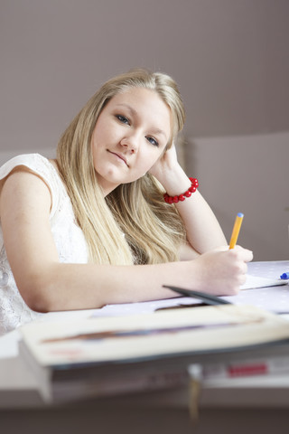 Portrait of teenage girl at her desk stock photo