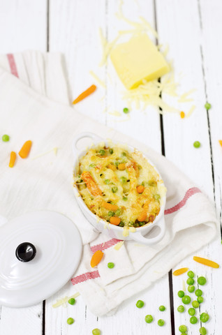 Gratin from macaroni, carrots and peas stock photo