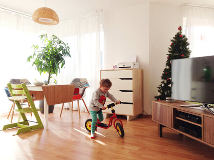Toddler with scooter in living room - AFF000029