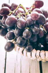 Basket of blue grapes on wooden table, close-up - SARF000274