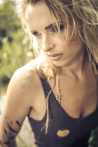 Blond woman in tank top outdoors stock photo