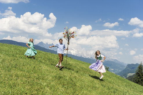 Austria, Salzburg State, Altenmarkt-Zauchensee, three children with Palmbusch on alpine meadow - HHF004774