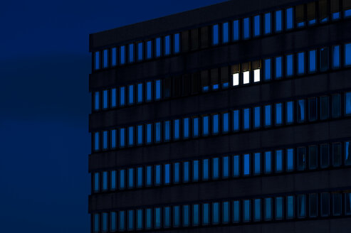 Germany, Dusseldorf, Lighted windows in office building - KJF000296