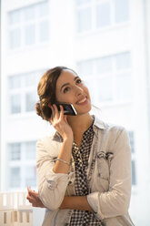 Portrait of young female architect telephoning in office - FKF000454