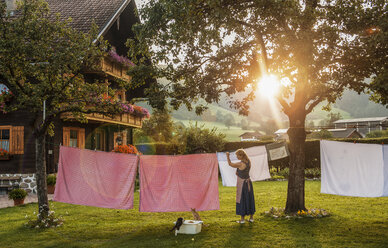 Man hanging up laundry outdoors stock photo