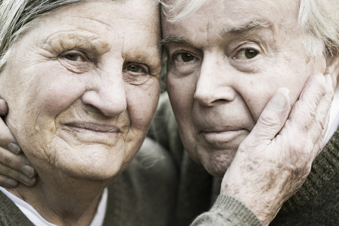Portrait of senior couple head to head stock photo