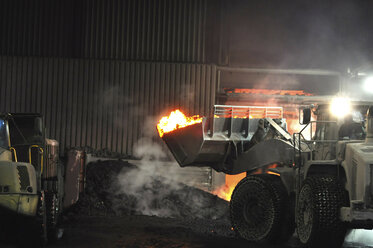 Germany, Steel mill, removal of slag with shovel excavator - SCH000085