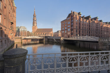 Germany, Hamburg, old warehouse district, Speicherstadt with St Catherine's church at sunrise - RJF000020