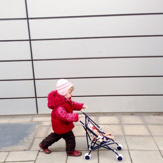 Little girl with doll carriage, Munich, Bavaria, Germany - GSF000788