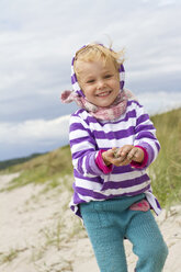 Denmark, Ringkoebing, little girl walking on the beach - JFEF000281