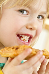 Portrait of little girl eating - JFEF000288