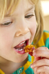 Portrait of little girl eating, close-up - JFEF000292