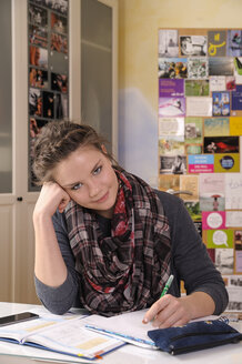 Portrait of female pupil at her desk - BTF000323