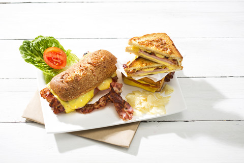 Ciabatta und Sandwich mit Käse, Schinken, Speck, Tomate und Salat, lizenzfreies Stockfoto