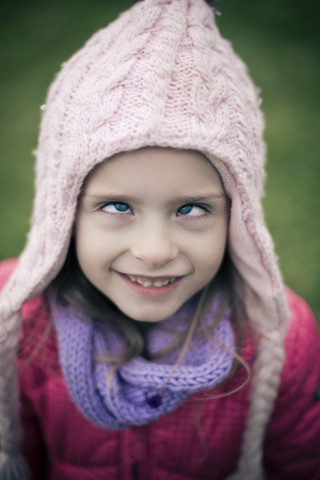 Portrati of cross-eyed little girl wearing winter clothing stock photo