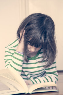 Little girl reading book at home - LVF000848