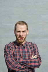 Portrait of angry young man wearing checkered shirt - BR000161