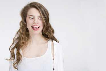 Portrait of teenage girl making a face - MAEF008188