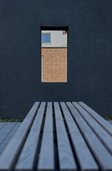 Germany, North Rhine-Westphalia, Aachen, dark facade and bench in front - HL000430