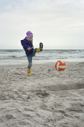 Denmark, Jutland, Vejers Strand, girl kicking ball on beach - JBF000086