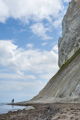 Denmark, Mon island, mother and daughter walking below Mons Klint chalk cliffs - JBF000082