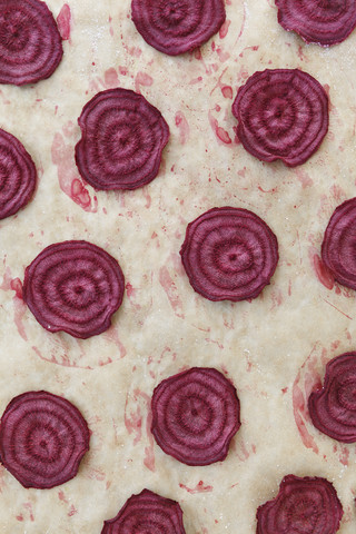 Baked slices of beetroots on baking paper, detail stock photo