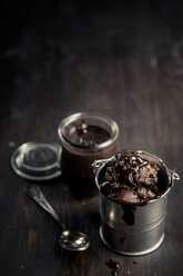 Little metal basket of chocolate ice cream and preserving jar of chocolate sauce - SBDF000657