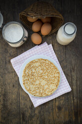 Pancake on plate and ingredients, eggs, milk and flour - LVF000886