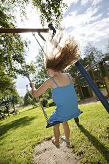 Germany, Coburg, teenage girl on a swing in the park - VTF000179