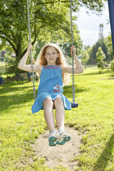 Germany, Coburg, teenage girl on a swing in the park - VTF000178