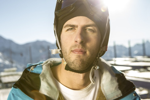 Austria, Vorarlberg, Riezlern, Portrait of young man wearing ski goggles stock photo