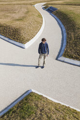 Germany, Baden-Wurttemberg, Teenage boy standing at crossing - WDF002424